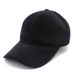 Close-up of black faux mink baseball cap showing dense plush texture and 6-panel structure