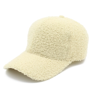 Close-up detail of soft cream faux lamb wool fabric on a minimalist baseball cap