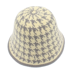 Detail of knit bucket hat featuring classic beige and grey houndstooth pattern weave