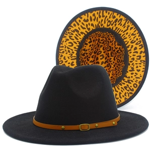 Detail of fedora hat showing black felt exterior and leopard print lining with buckle
