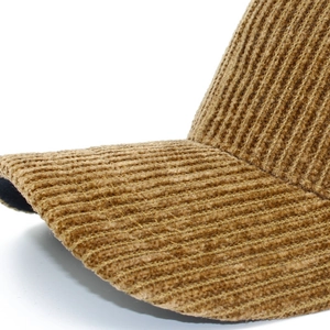 Close-up of camel corduroy texture and sturdy curved brim on a retro baseball cap