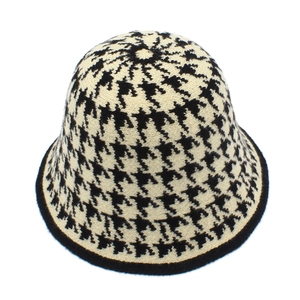 Close-up of the black and white houndstooth knit texture and edge of this bucket hat