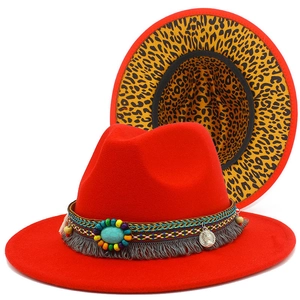 Detail of red fedora hat featuring leopard print lining and bohemian beaded tassel band