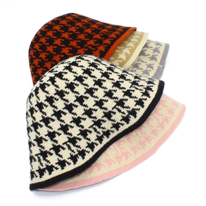 Detail view of knitted houndstooth bucket hats in various color combinations for winter