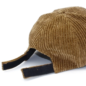 Rear view of brown corduroy baseball cap with adjustable black velcro strap on white background