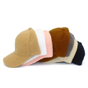 Assorted colors of soft sherpa fleece baseball caps showing warm autumn winter textures