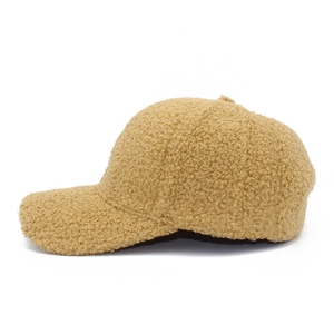 Detailed side view of camel faux shearling texture on a warm baseball cap for winter