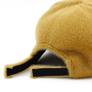 Detail of faux mink fur texture on ginger baseball cap with black adjustable strap