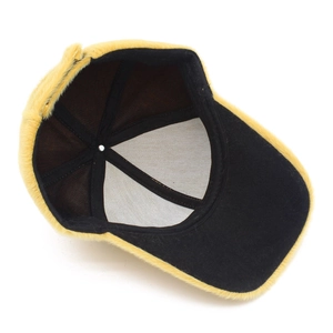 Detailed interior view of a yellow plush faux fur baseball cap with black fabric lining