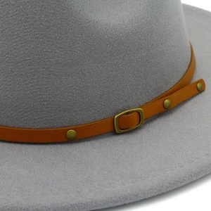 Detail of grey wool fedora hat with brown leather belt strap and vintage metal buckle