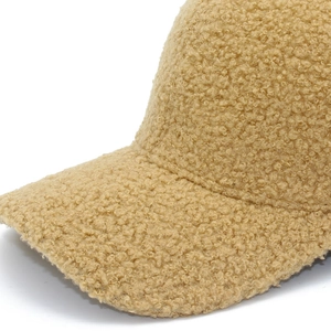 Detailed close-up showing texture of khaki teddy fleece fabric on the baseball cap
