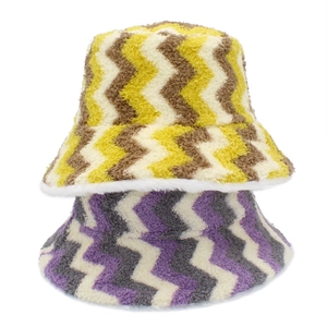 Detail of striped plush bucket hats in yellow brown and purple wavy faux fur patterns