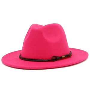 Detail of fuchsia fedora hat with fuchsia wide brim and black braided rope decoration