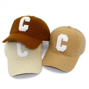 Three lamb wool baseball caps in brown, cream, and khaki with white letter C embroidery