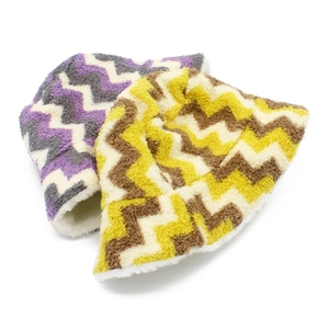 Detail of plush bucket hat featuring wavy chevron patterns and warm fleece lining texture