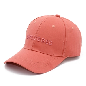 Detailed view of 3D embroidered UNPLUGGED text on a coral pink cotton baseball cap