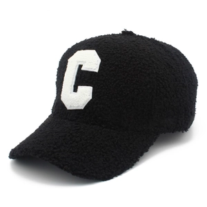 Close-up of black fuzzy lamb wool baseball cap with white C letter embroidery