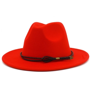 Detail of red fedora wool hat showing brown braided cord and bronze arrow metal buckle