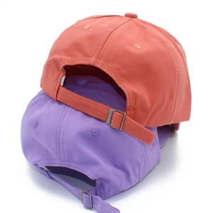 Detail view of cotton baseball caps showing adjustable metal slide buckle and back strap
