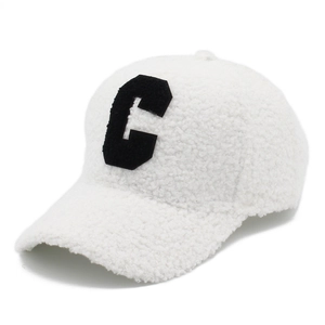 White fuzzy sherpa baseball cap with black letter C embroidery on a clean background