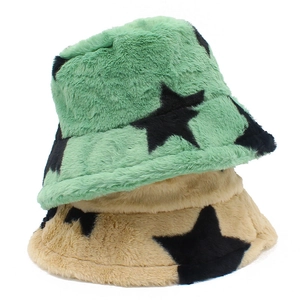 Detailed macro view of mint green and camel faux fur bucket hats with star patterns