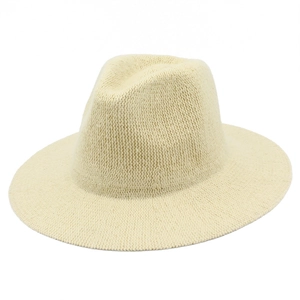 Close-up of fine chenille knit texture on a cream foldable fedora hat with a flat brim