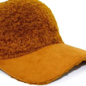 Close-up of the mustard yellow teddy fleece texture on the warm autumn baseball cap