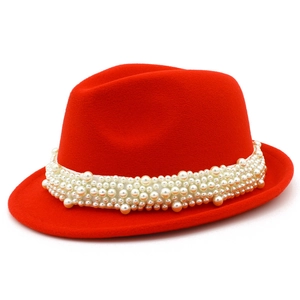 Elegant red wool fedora jazz hat with pearl decoration band on a white background
