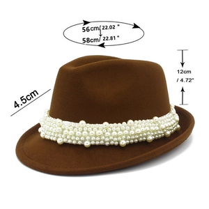 Detail of dark brown wool fedora hat featuring a wide band of clustered white pearls
