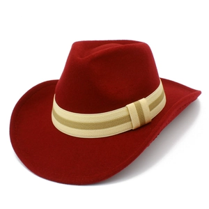 Detail of dark red western cowboy hat with a striped band and wide brim design