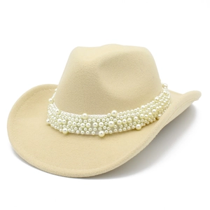 Detail of western beige cowboy hat featuring a wide band of assorted white pearls decoration