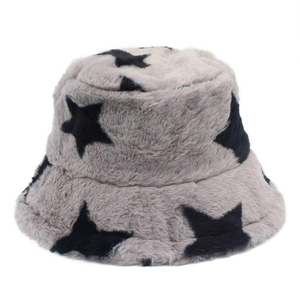 Close-up of greige faux rabbit fur bucket hat with black star patterns for winter warmth