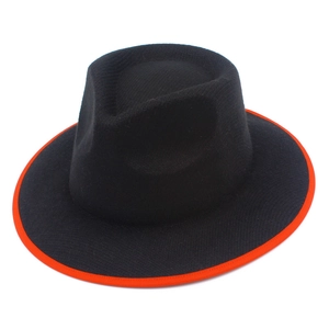 Detail shot of black wool jazz hat featuring vibrant orange contrast binding on the brim