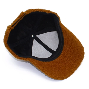 Detail view of the brown teddy fleece baseball cap showing inner lining and sweatband