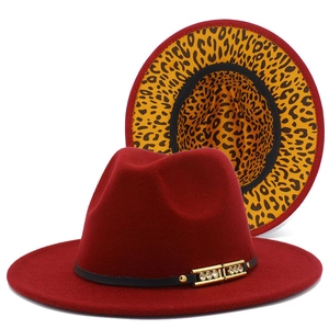 Detail of dark red fedora featuring leopard print lining and golden buckle with rhinestones