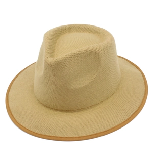 Macro shot of khaki woven fedora featuring dark brown fabric piping and straw texture