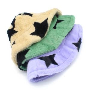 Close-up of soft faux rabbit fur bucket hats with star prints in beige, green and purple