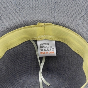 Detail of soft knit fedora hat interior showing the 35% cotton material and wash label