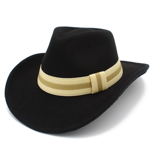 Detailed close-up of a black wool felt cowboy hat with beige striped ribbon trim