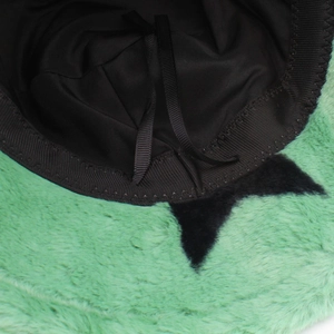 Detail view of the green faux fur bucket hat lining with adjustable inner drawstrings