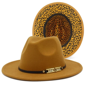 Detail of fedora hat showing leopard print brim, black ribbon, and golden rhinestone buckle