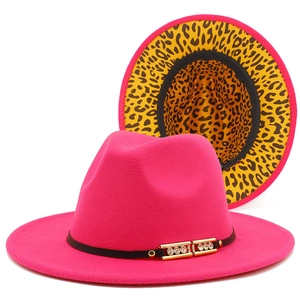 Detail of rose red wool felt fedora featuring gold buckle and leopard print brim lining