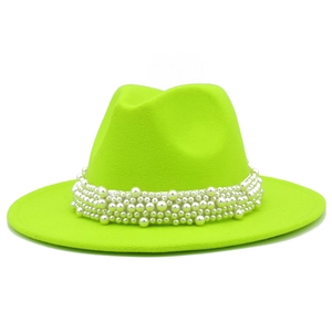 Detalle del sombrero fedora verde neón con elegantes perlas blancas de lujo incrustadas