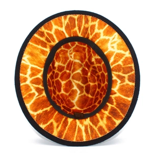 Detail view of fedora hat interior with giraffe print lining and fabric care label