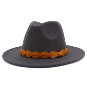 Detailed texture of dark grey wool fedora hat featuring a brown braided leather band