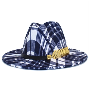 Detail view of navy blue plaid fedora hat with black leather band and gold feather charm