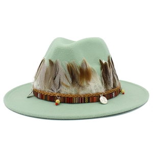 Detail view of mint green wool fedora with bohemian feather trim and woven rope band