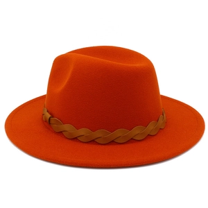 Detail of orange wool felt fedora with a brown braided leather band for autumn fashion
