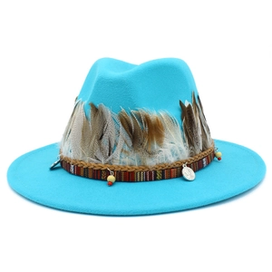 Detail of bright blue fedora hat with feather, braided leather, and ethnic charm accents