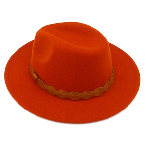Detailed view of the orange wool fedora hat featuring a brown braided leather band